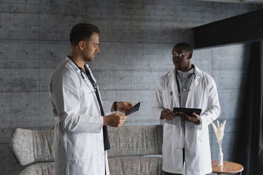 Two doctors in a medical office discussing an x-ray, emphasizing teamwork and healthcare expertise.