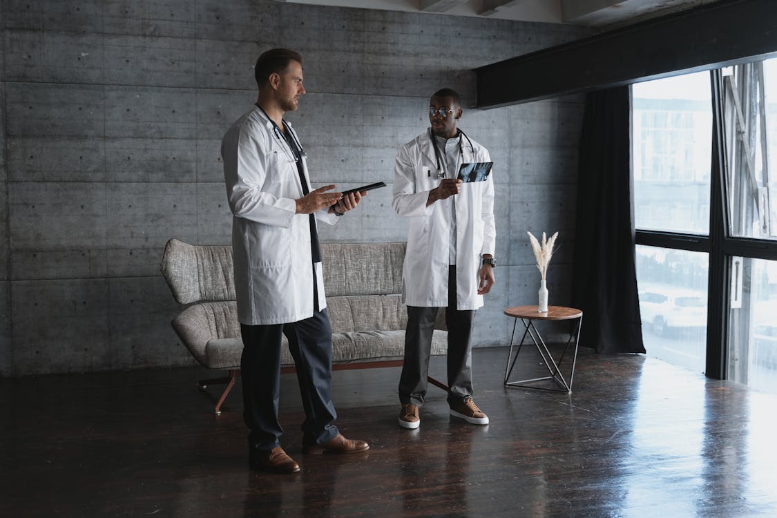 Man in White Lab Gown Holding Xray Film