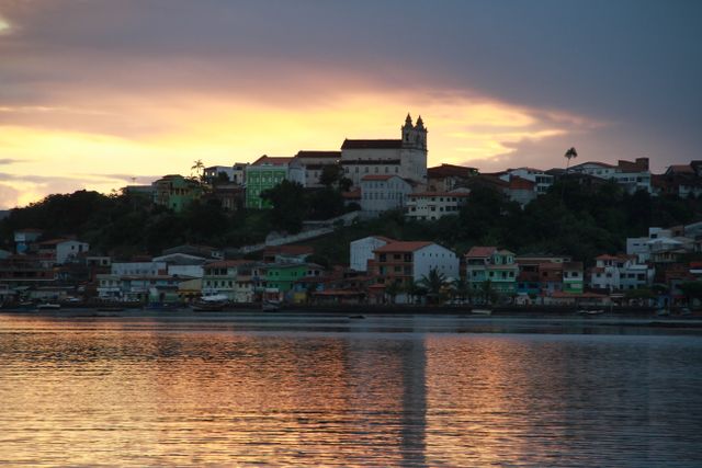 Picturesque sunset view of Camamu's colorful waterfront with a stunning sky.