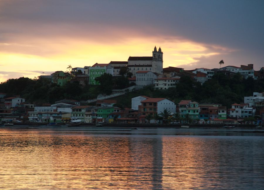 Picturesque sunset view of Camamu's colorful waterfront with a stunning sky.