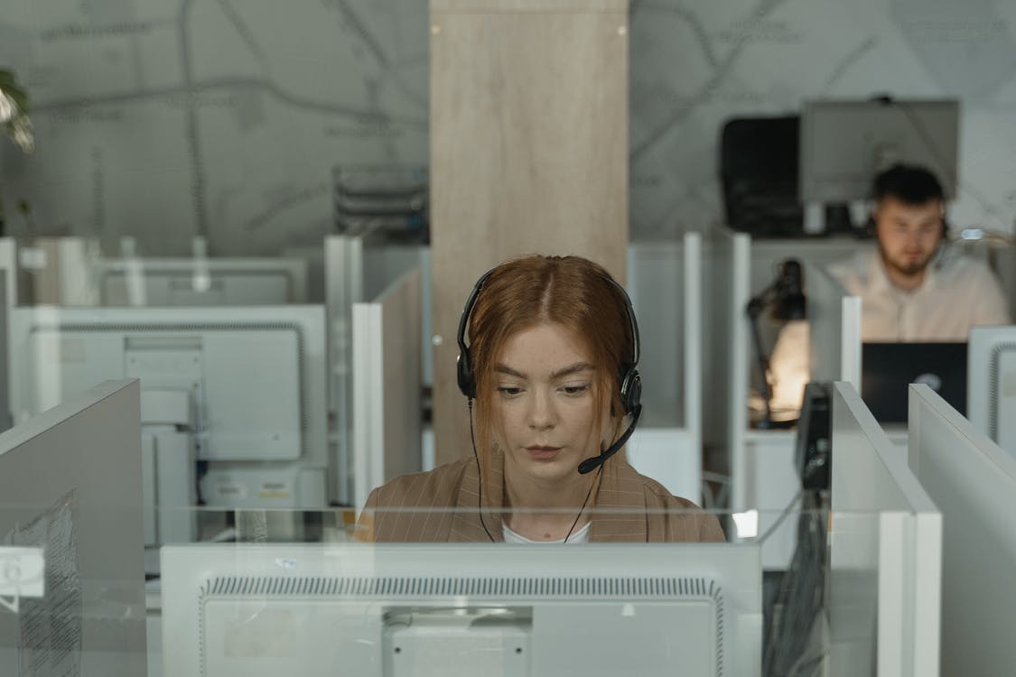 Free A Woman in Brown Blazer Working in the Office Stock Photo