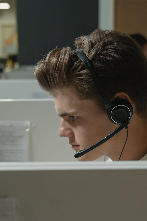 Free Boy in Black Headphones Looking at the Computer Stock Photo