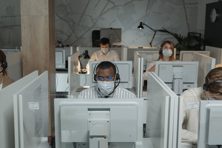 People Wearing Face Masks While Working In The Office
