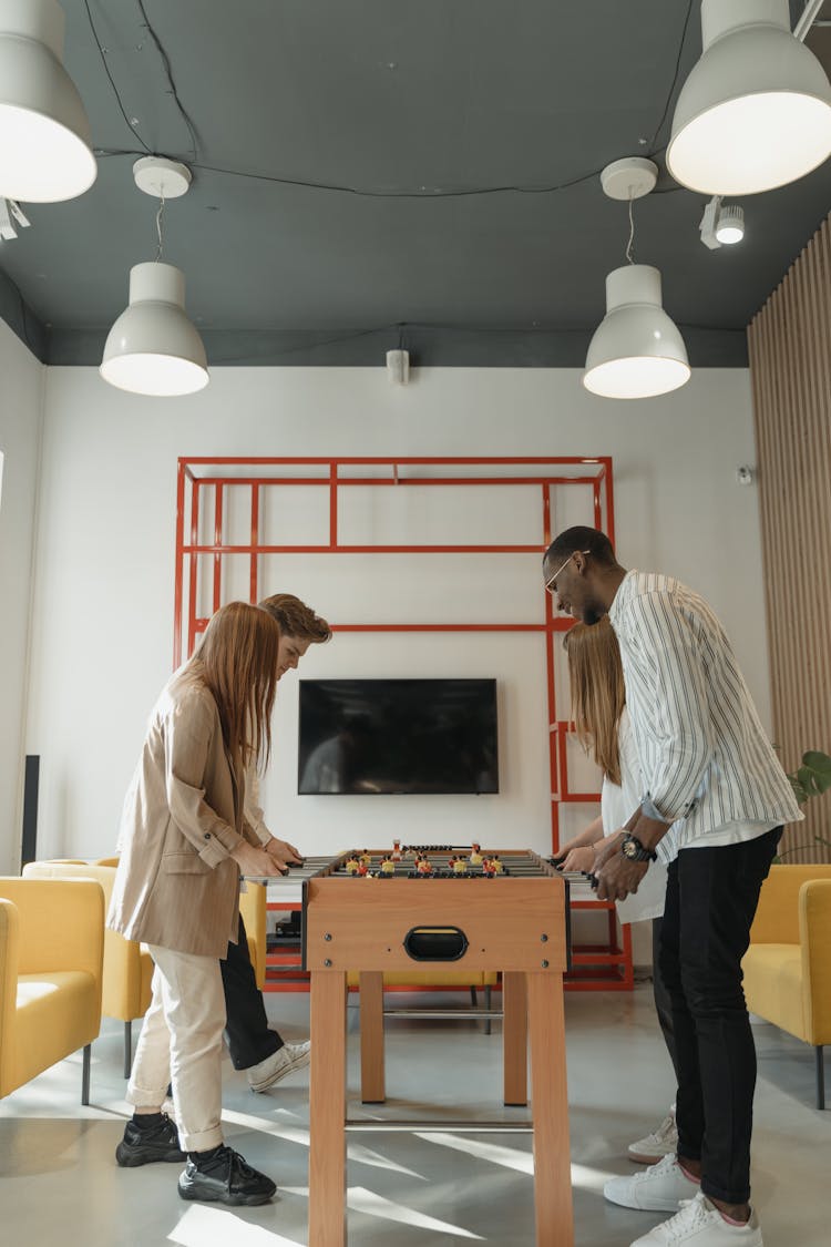 Side View Of A People Playing Table Football 