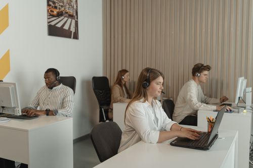 Free Office scene with call center employees at work, focusing on teamwork and productivity. Stock Photo