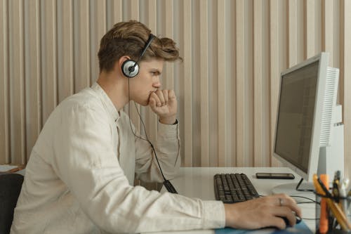 Free Side View of a Man using Computer Stock Photo