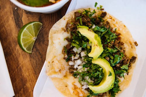 A Delicious Taco with Slices of Avocado in Top View