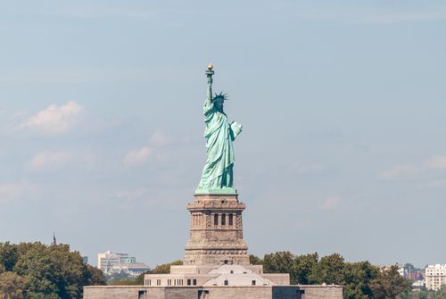 Free Iconic view of Statue of Liberty with a clear blue sky in New York City, USA. Stock Photo