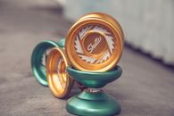 Green and Gold Yo-yos on Gray Floor