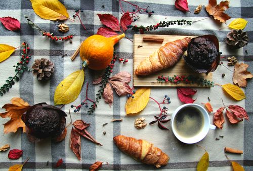 Free Top view of autumn breakfast with croissants, coffee, and seasonal decor. Stock Photo