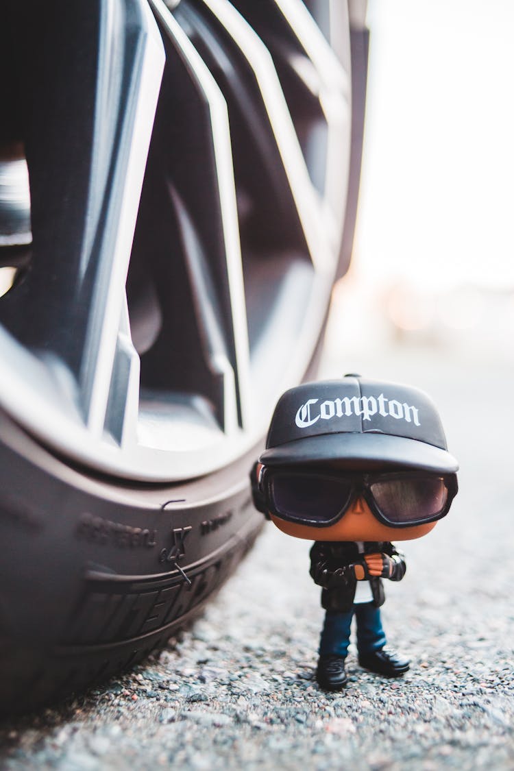 Toy Miniature Of Hip Hop Musician Near Car