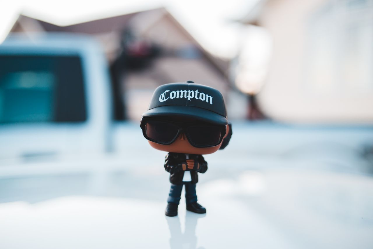 creative little miniature of cool man from hip hop culture placed on w