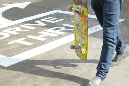 Free Person Holding Yellow Skateboard Stock Photo