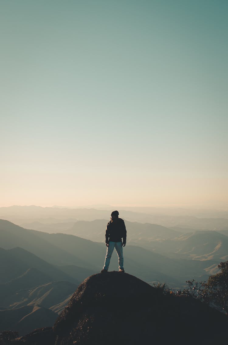 Man Watching Sunrise In Mountains