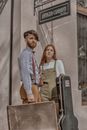 Stylish musicians with guitar case and suitcase