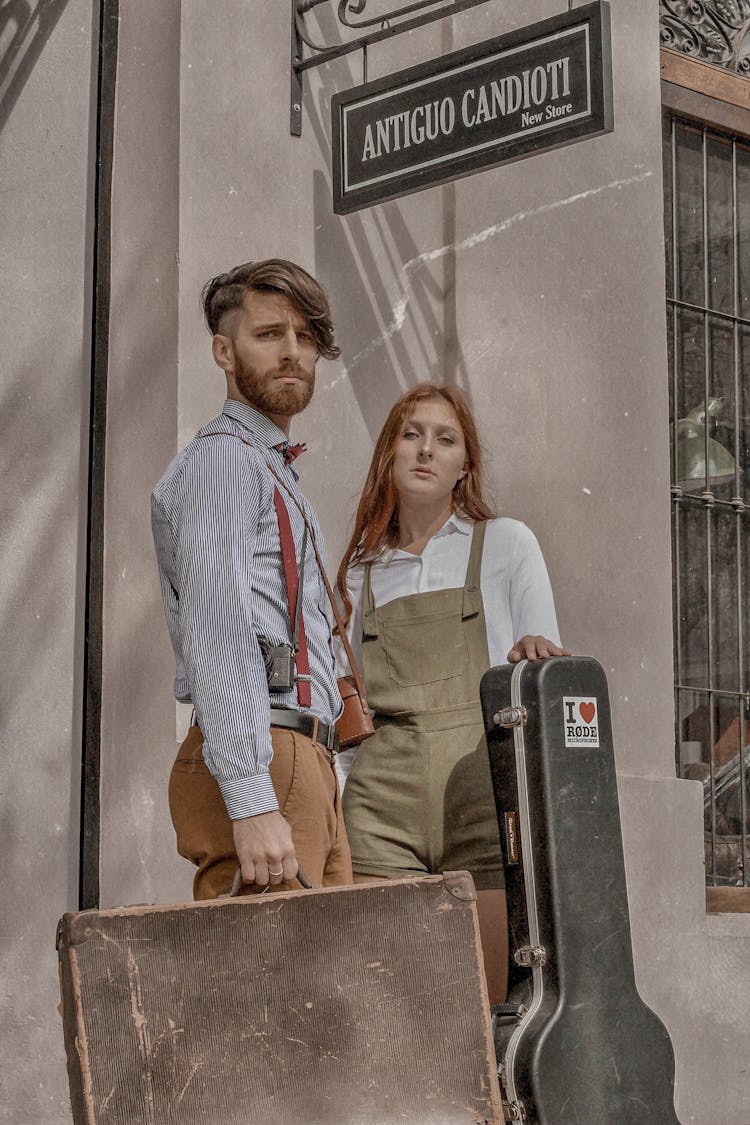 Stylish Musicians With Guitar Case And Suitcase