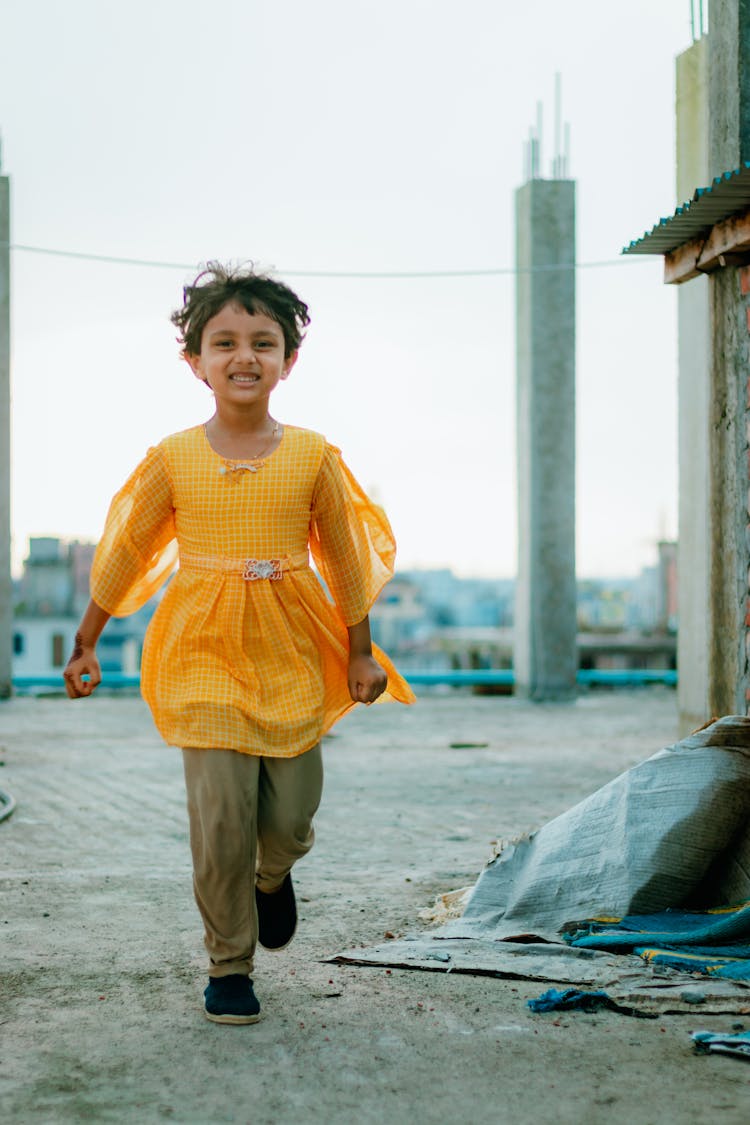 Cute Girl Running On A Street