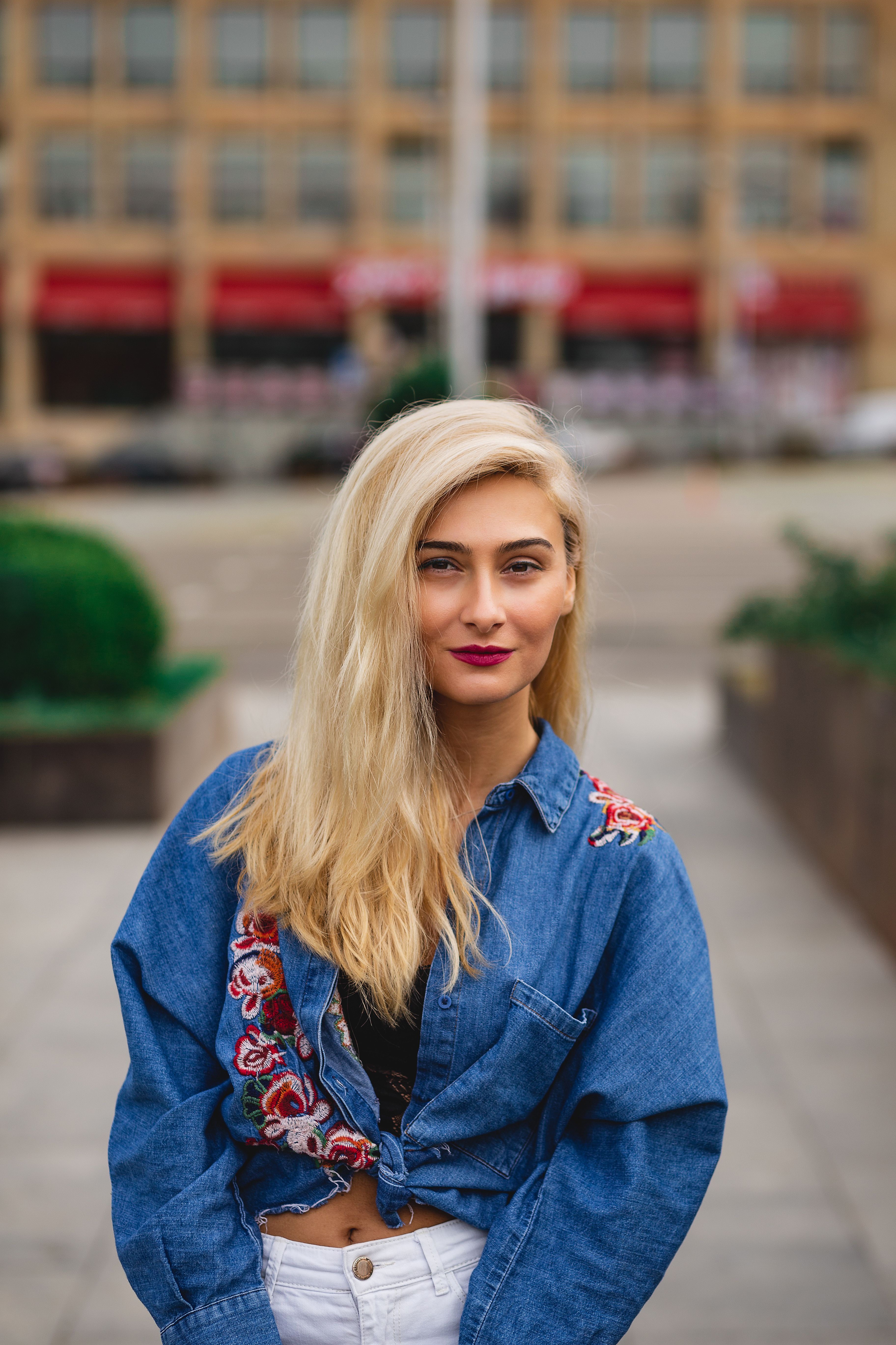 Woman in Blue Denim Jacket sitting on the Concrete Bench · Free Stock Photo