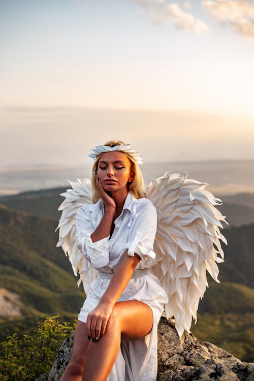 Woman in White Long Sleeve Dress and White Wings