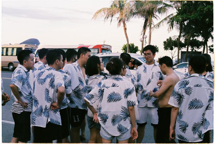 People On City Street In Matching Shirts