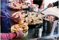 Person Slicing Meat on Table