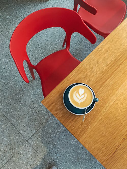 Cup of cappuccino on table in outdoors cafe