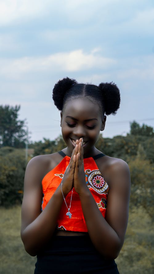 A Smiling Woman with her Hands Together 