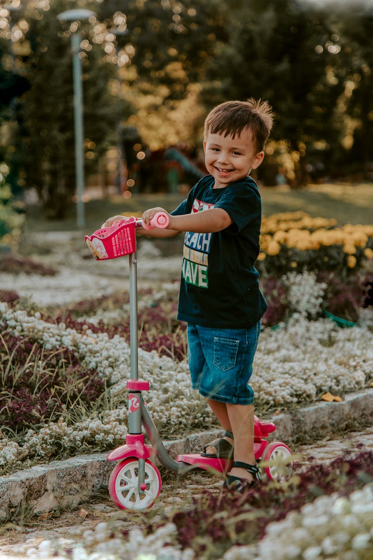 Smiling Boy Riding Scooter