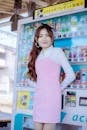 Woman in Pink Dress Leaning against Vending Machine