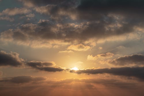 Free Cloudy sky at sunrise in rays of sun Stock Photo
