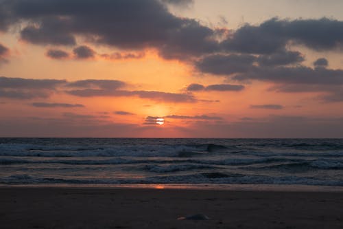 Scenic sunset sky over waving sea