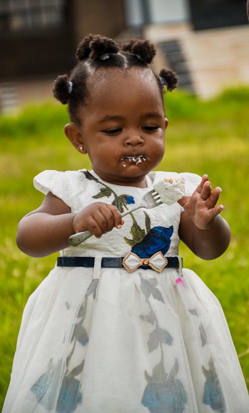 Little Girl Eating Ice Cream with Fork 