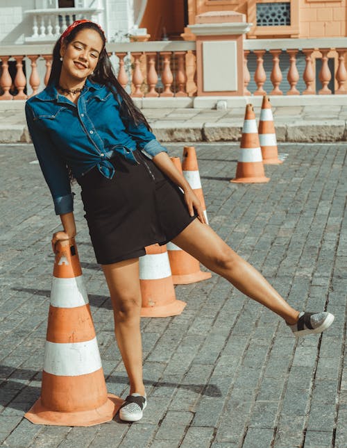 Young Woman Posing near Traffic Cone