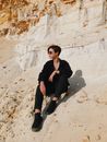 Woman in Black Jacket Sitting on White Sand