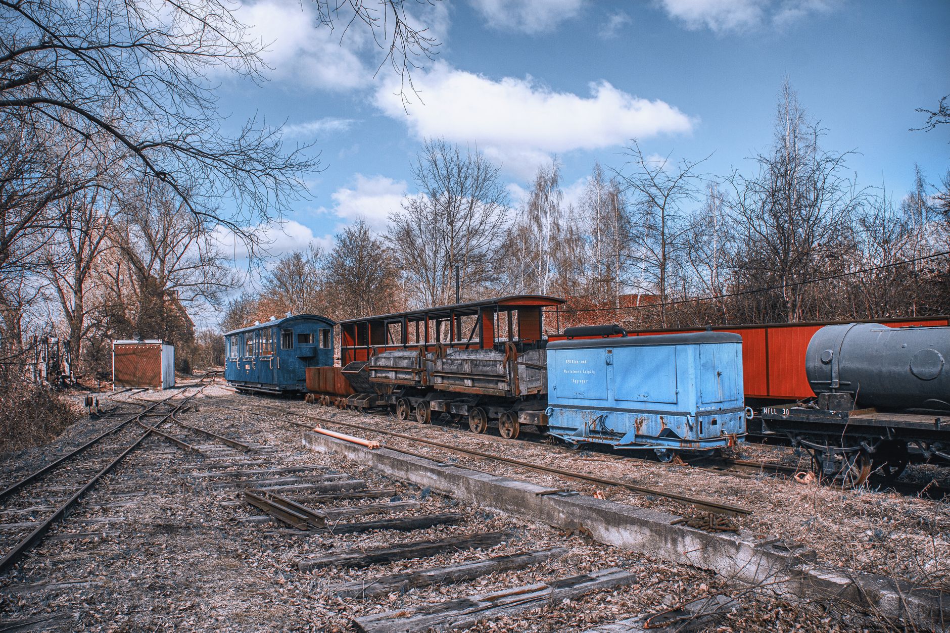 Explore this abandoned train yard in Leipzig, Germany, featuring vintage trains and rusty tracks.