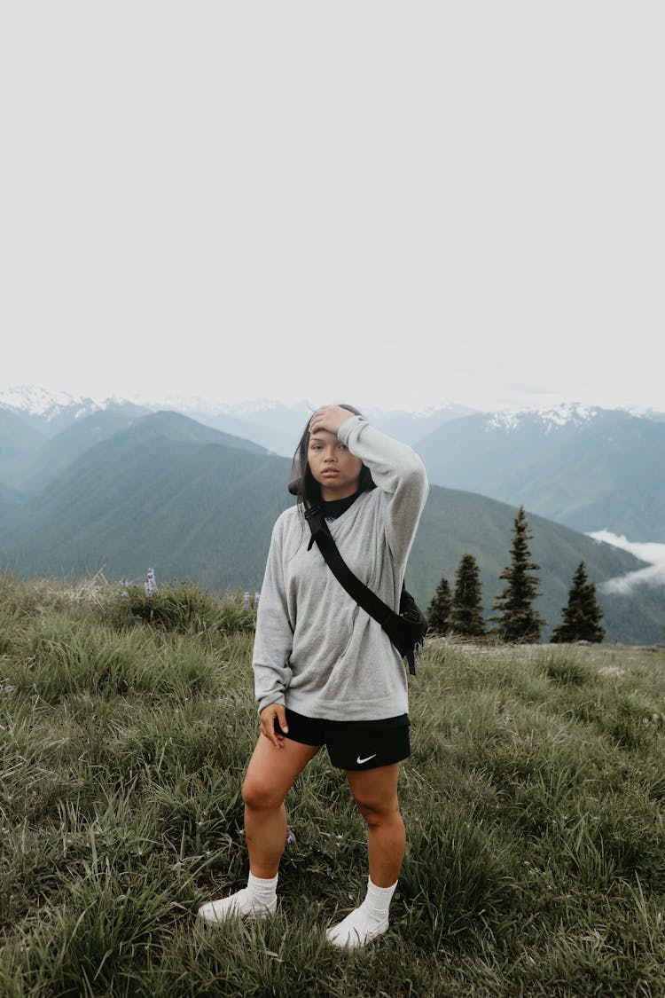 Young Ethnic Woman Standing On Hill Slope