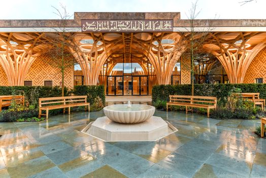 White Concrete Fountain Near Wooden Benches