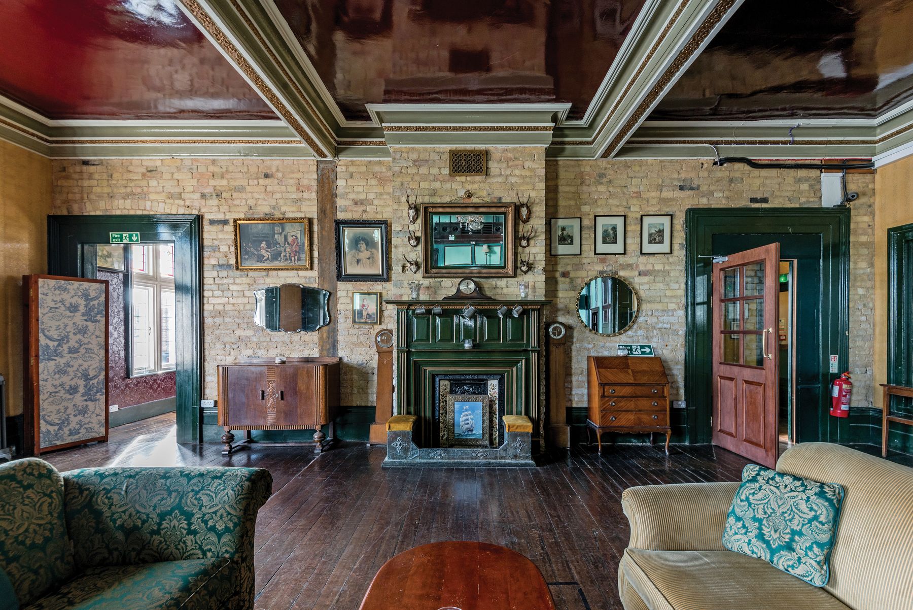 Elegant apartment room with ornate fireplace, tall proportions and a restrained mix of old and new furniture