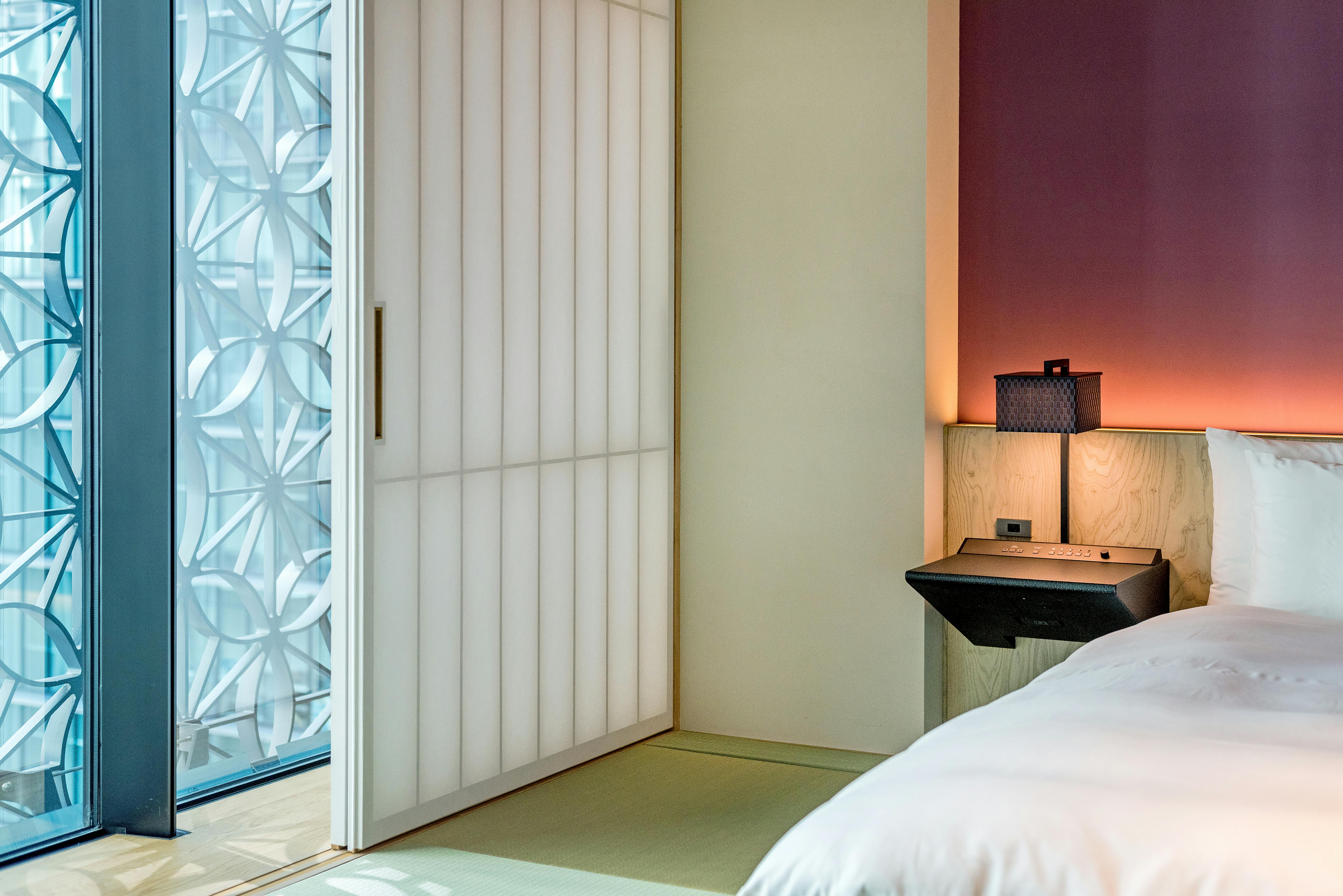 Elegant minimalist bedroom featuring stylish decor and ambient lighting.