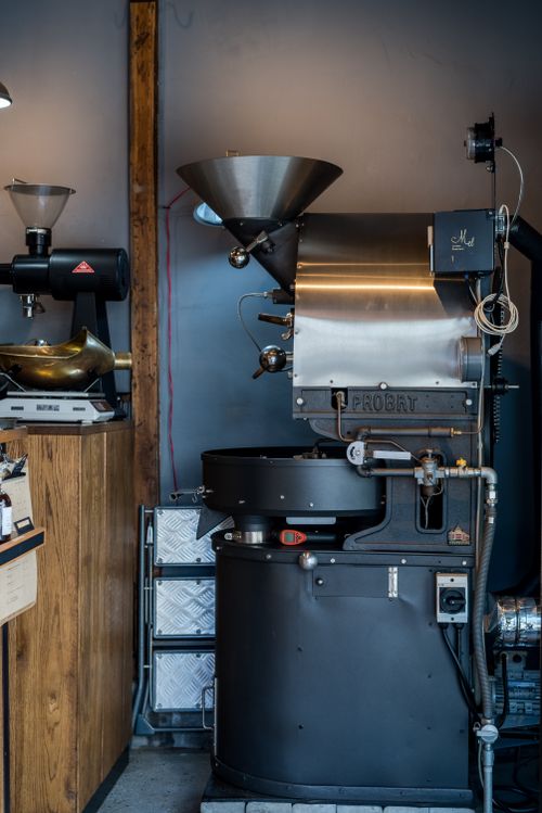 Free High-quality image of a professional coffee roaster machine in a modern café setting, showcasing industrial design. Stock Photo