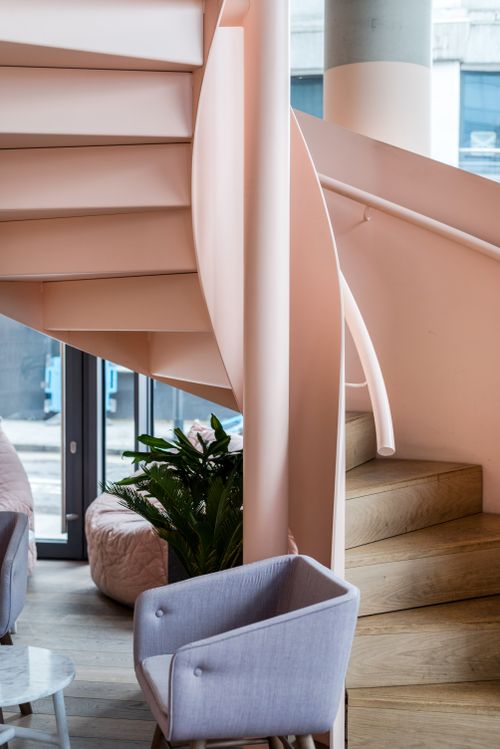 Free Elegant modern interior featuring a stylish spiral staircase and chic decor. Stock Photo