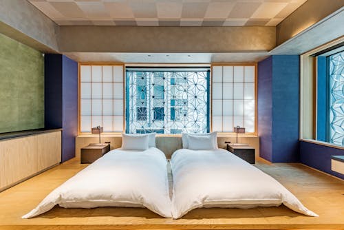 Free Single Beds Inside a Hotel Room Stock Photo