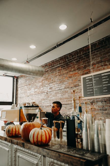A scene of a quiet café setting in Charlottesville with a thoughtful professional in the foreground, reflecting the atmosphere of focus and determination often experienced during the job application process.. Thanks to Emmy Paw for the photo