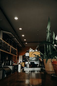 Interior of contemporary coffee house with long wooden counter with modern coffee machine and coffee making equipment