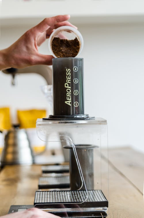 Free Pouring Coffee Beans in a Coffee Machine Stock Photo