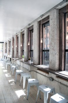 Bright and minimalist coffee shop interior with wooden elements and natural light.
