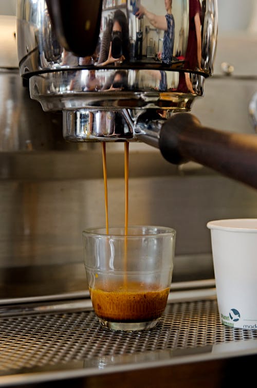 Free Coffee Dripping From Coffee Machine Into A Glass  Stock Photo