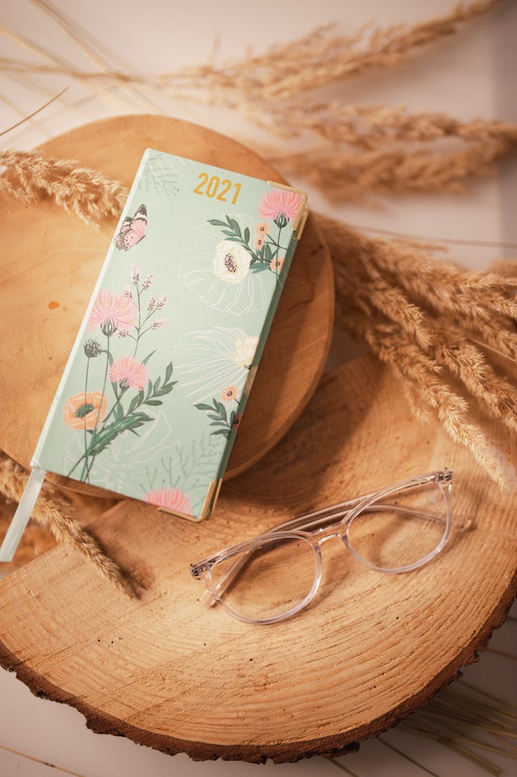 Ladies 2021 Year Diary And Eyeglasses On Wooden Boards