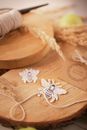 Threads and applique work ornaments on wooden board