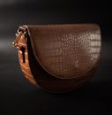 Classy leather bag on black surface
